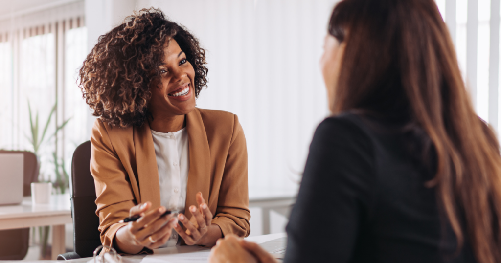 two women sitting across from each other during a consultation