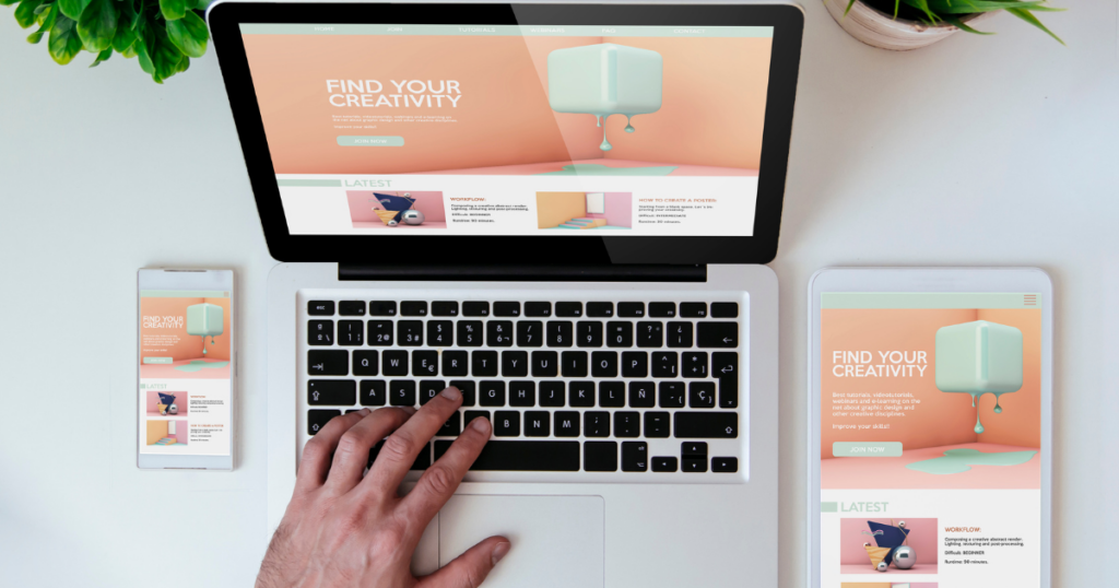 Top view of a mobile phone, laptop, and tablet all open to the same website to illustrate that great website design translates across all platforms.