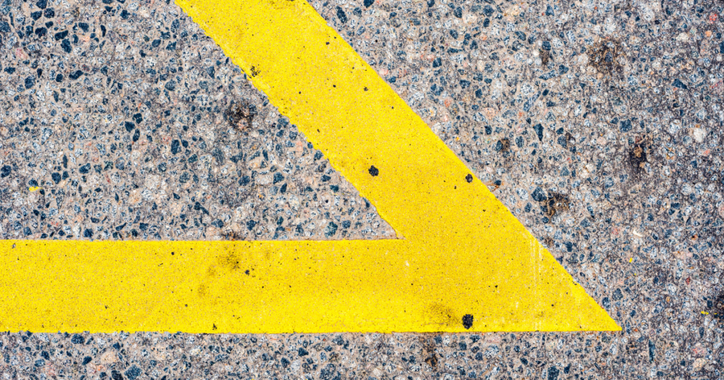 yellow road paint in a sharp angle on asphalt